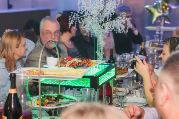 Food tiered serving stand guests at table