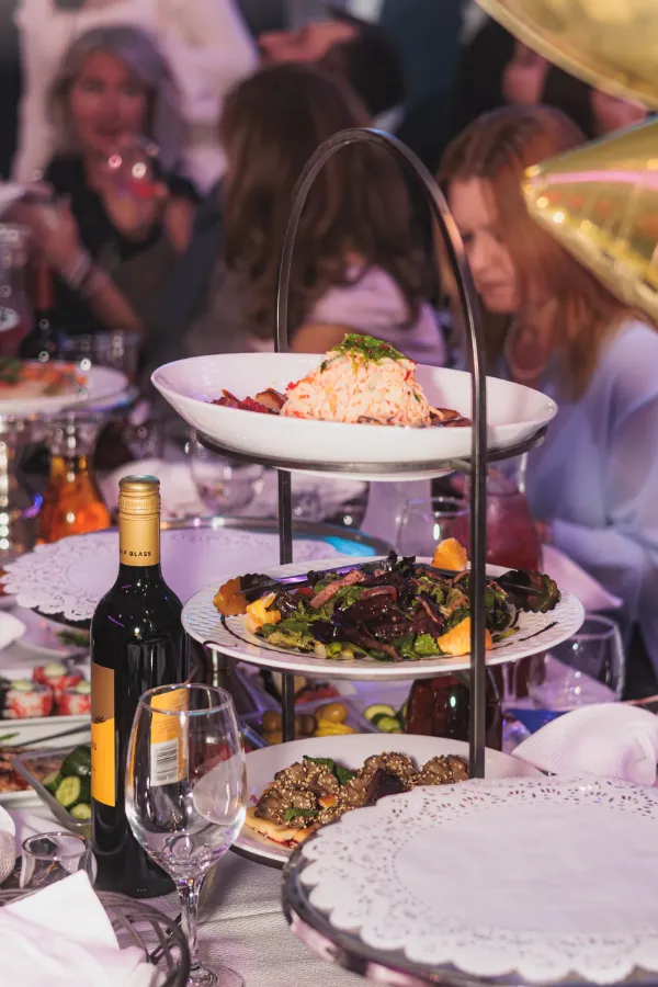 Tiered food display wine bottle table setting