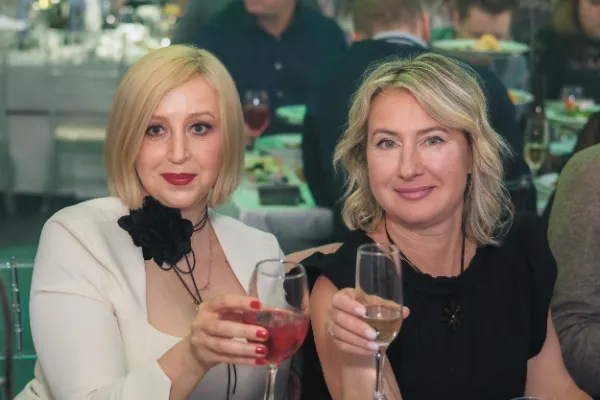 Two blonde women toasting champagne