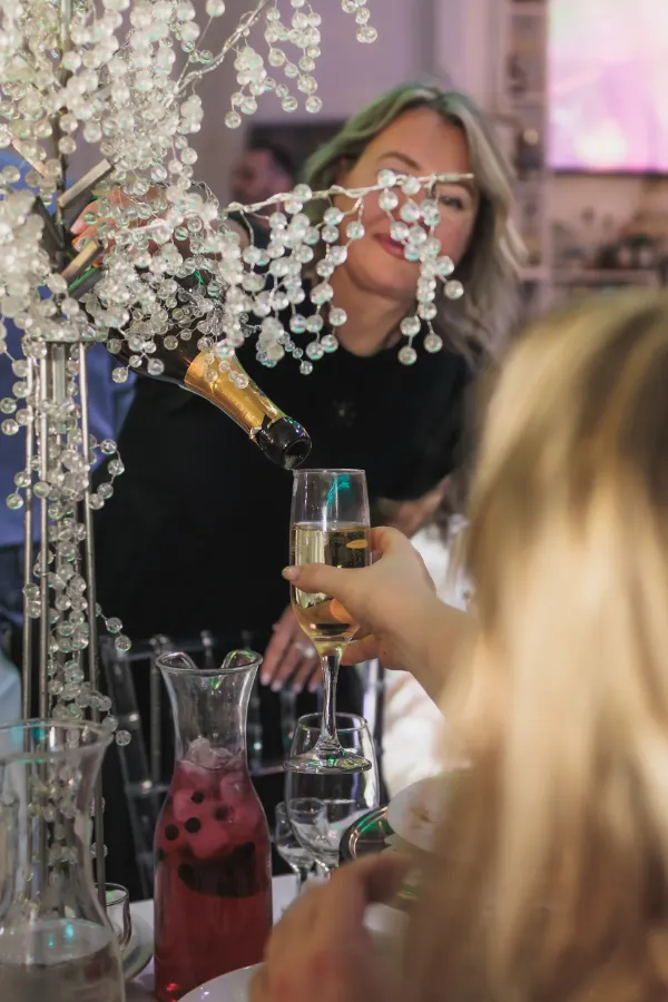 Woman pouring champagne into flute