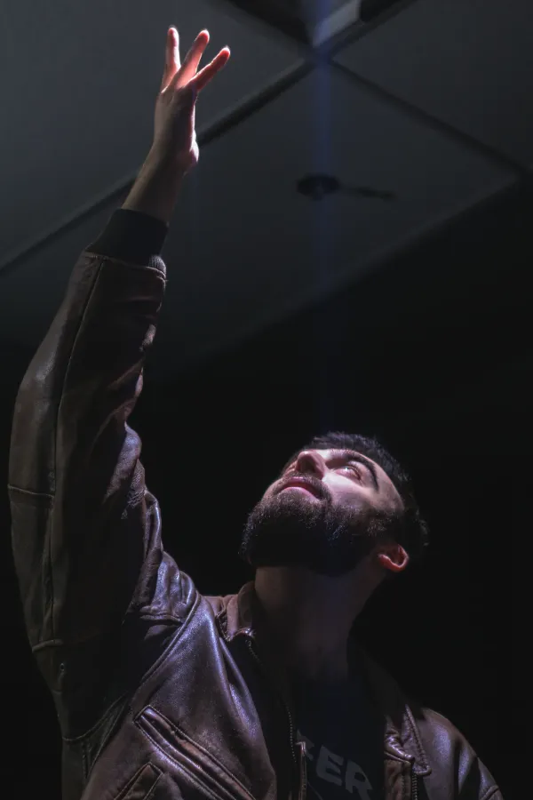 Bts actor leather jacket arm raised dramatic lighting