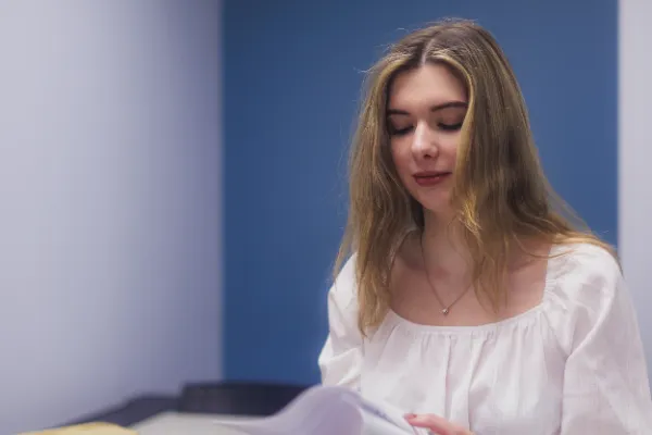 Bts actress white top reading script blue wall