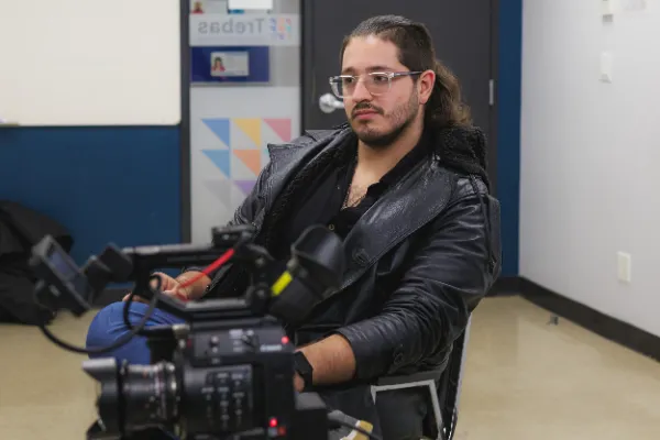 Bts crew member glasses long hair holding canon camera