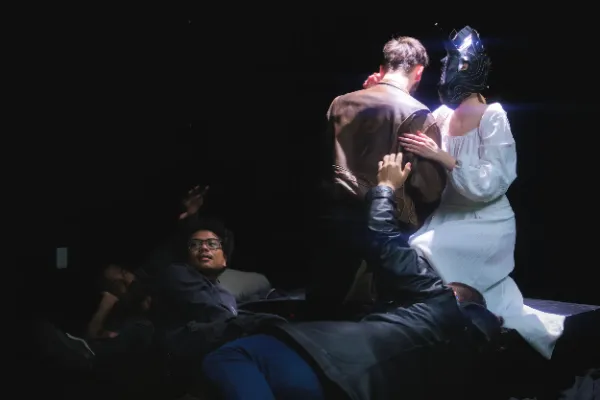 Bts director guiding actors masked actress embrace scene