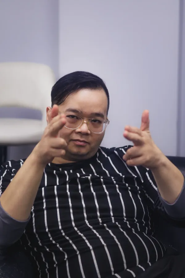Bts director striped shirt glasses pointing fingers portrait