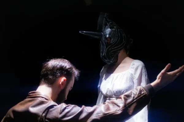 Bts scene actor facing masked actress white dress dark