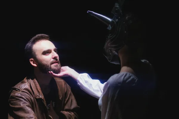 Bts scene masked actress touching actors face dark