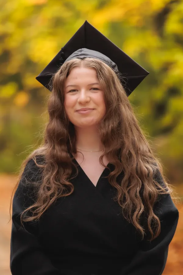 Grad girl black dress mortarboard headshot autumn
