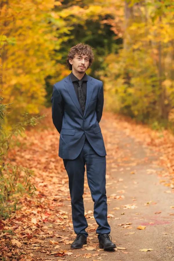 Grad guy blue suit full body autumn path