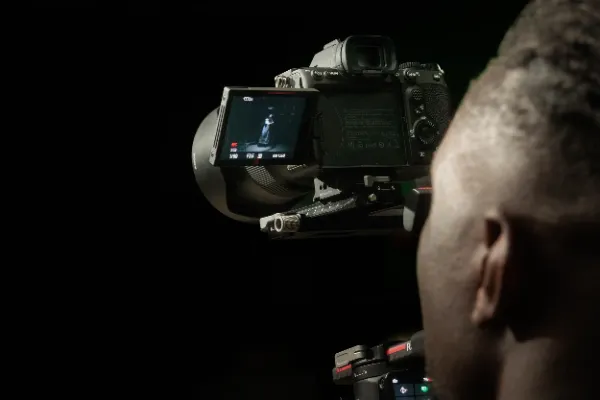 Bts mv over shoulder camera monitor showing vocalist dark studio