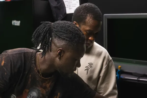 Bts mv two crew members reviewing footage dark room
