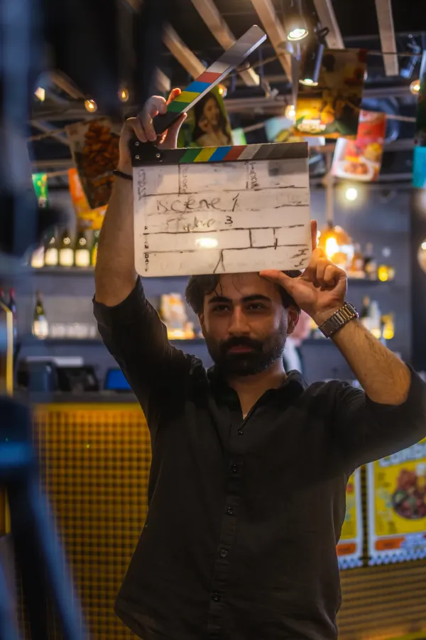 Crew member holding clapperboard scene1 take3 korean restaurant