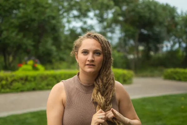 Female actor dreadlocks holding hair outdoor park portrait