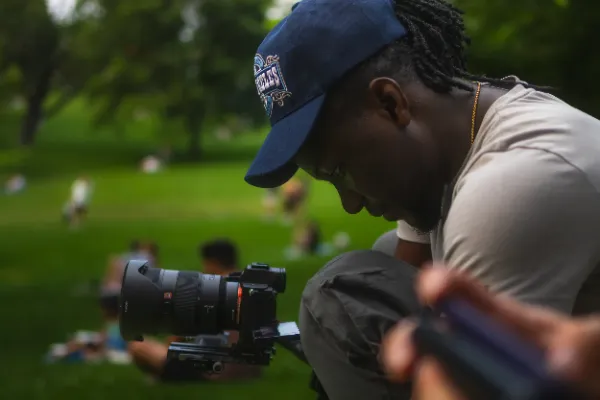 Cinematographer dreadlocks los angeles cap reviewing sony camera park