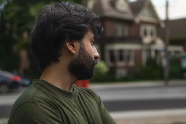 Crew member green shirt beard profile portrait residential street
