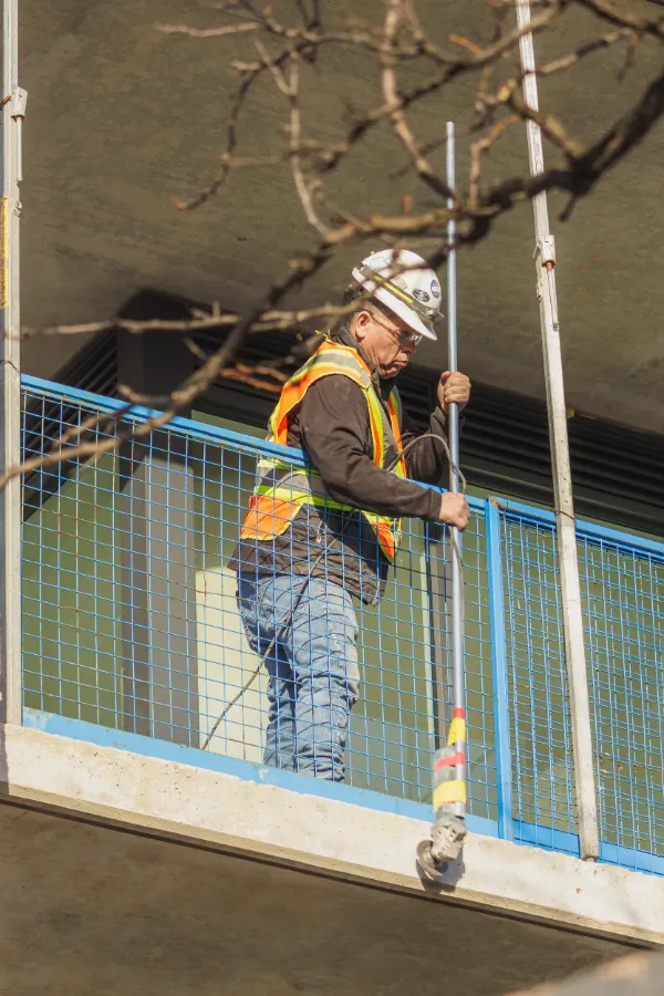 Construction worker hardhat hi vis vest scaffold building