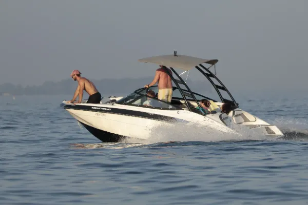 Group speedboat lake summer hazy four people on deck