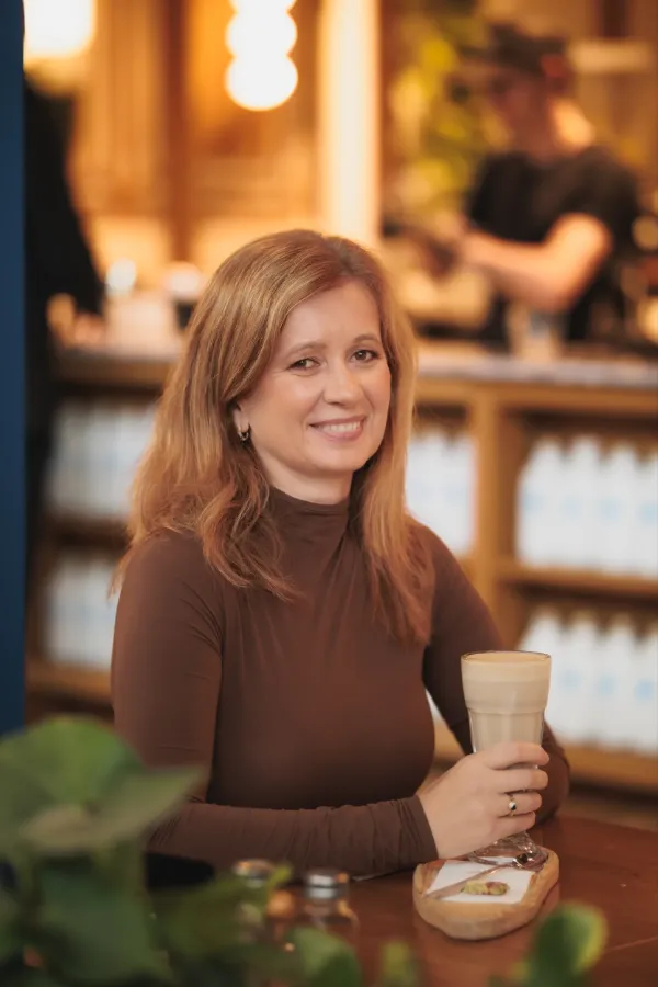 SF auburn hair brown turtleneck holding latte cafe smiling portrait 09