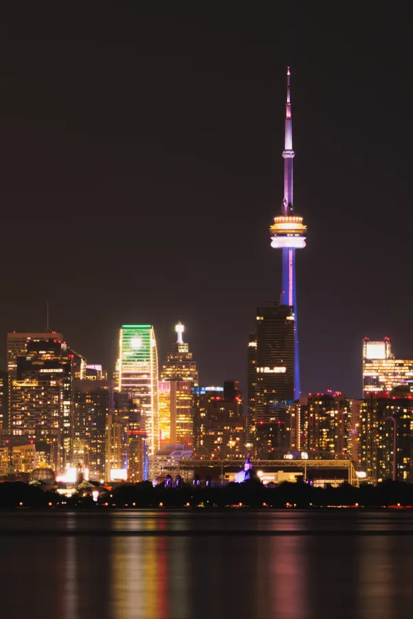 Toronto skyline cn tower pride lighting night vertical lake reflections