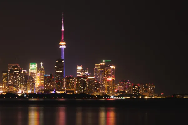 Toronto skyline cn tower pride lighting night wide from island