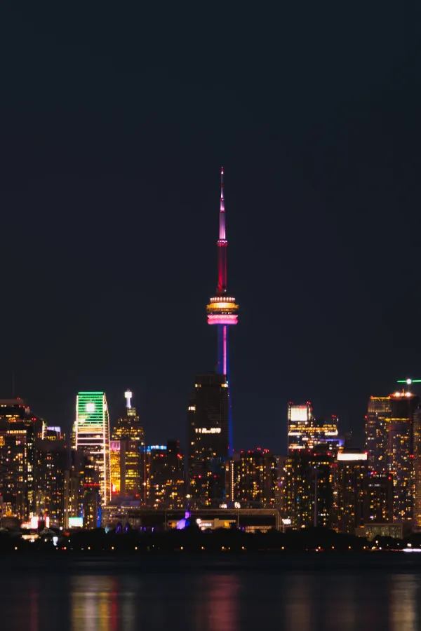Toronto skyline cn tower pride rainbow lighting night telephoto